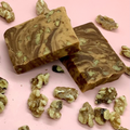 Marbled turtle fudge with pecans on a pink surface